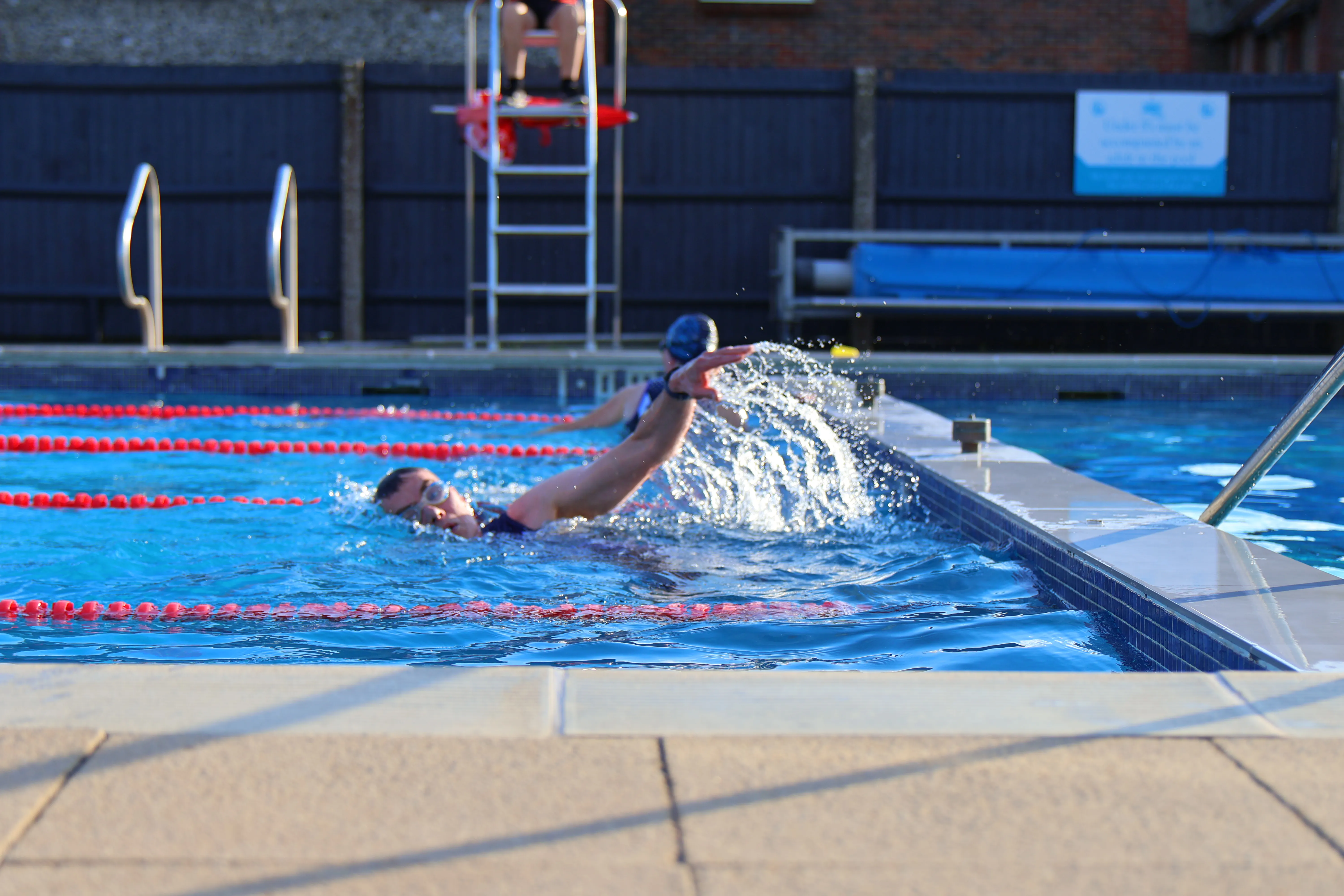 Athlete finishing swim leg in the pool at Arundel Lido